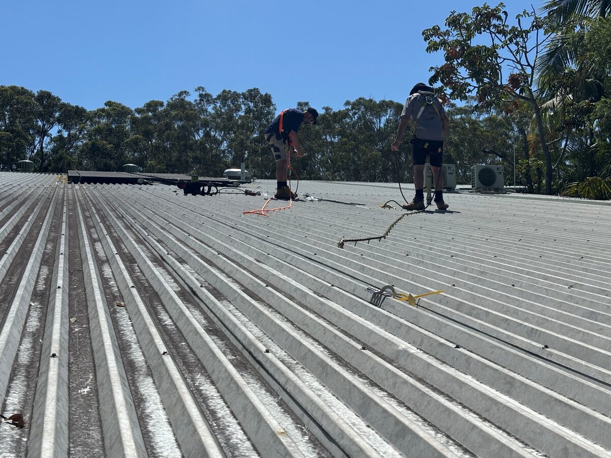Orara TV Solutions technicians installing cabling on a commercial roof