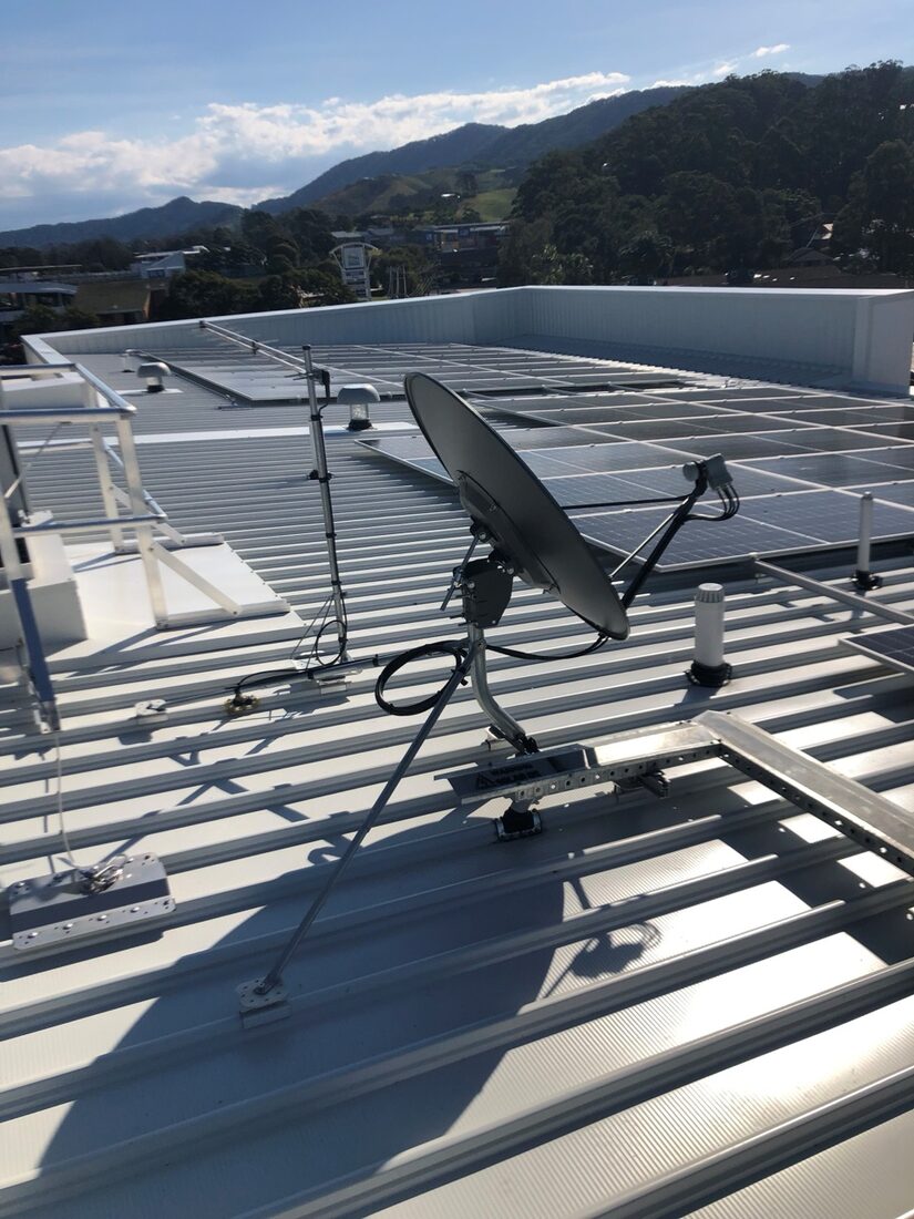 A VAST satellite dish installed on a Coffs Coast roof with the hinterland hills behind